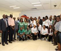 Group photograph of D'Tigress and male Total staff
